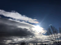 the sun is shining through a cloudy sky