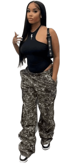 a woman in camouflage pants is posing for a picture