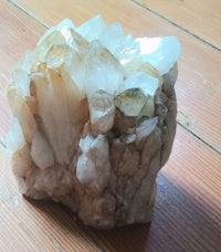 a piece of quartz sitting on top of a wooden floor