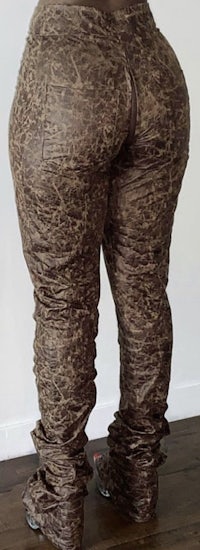 a woman wearing a pair of brown leather pants