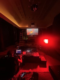 a man is playing video games in a dark room