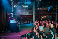 a dj is performing in front of a crowd of people