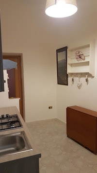 a small kitchen with a stove and sink