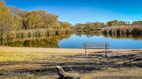 a bench next to a body of water