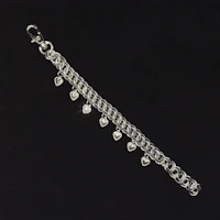 a silver chain bracelet with hearts on it