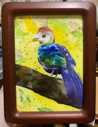 a painting of a colorful bird on a wooden frame