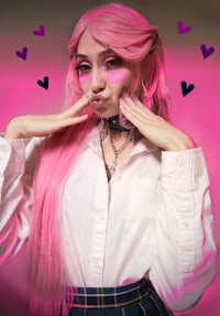 a girl with pink hair posing for a picture