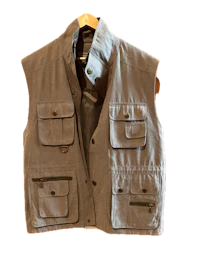 a men's grey vest hanging on a hanger