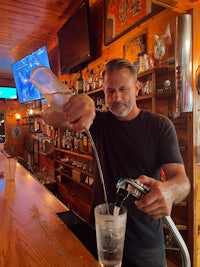 a man pouring water into a glass