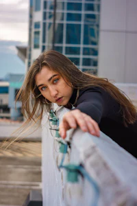 a woman leaning on a railing