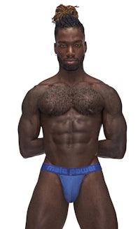 a man in a blue thong posing for a photo