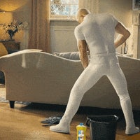 a man cleaning a living room with a bucket