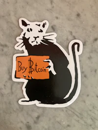a sticker with a cat holding a sign