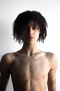 a young man with tattoos and a shirtless body