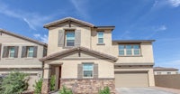 a two story home with two garages and a driveway