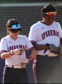 two softball players standing next to each other
