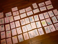 a collection of children's drawings on a wooden floor