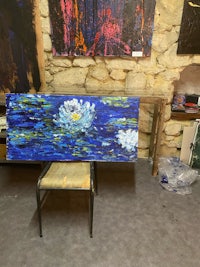 a painting of water lilies in a studio