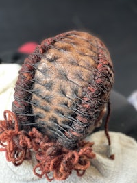 the back of a woman's hair with dreadlocks
