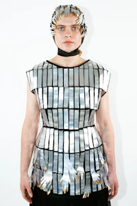 a woman wearing a dress made of metal