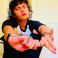 a young man posing with his hands in the air