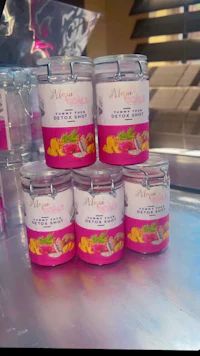 five jars of mango soap sitting on a counter