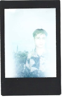 a black and white polaroid with a woman's face in it