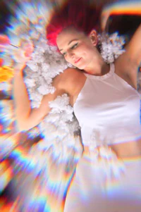 a woman with red hair laying on a bed