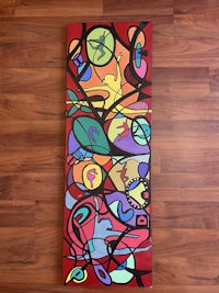 a colorful abstract painting on a wooden floor