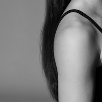 a black and white photo of a woman with long hair