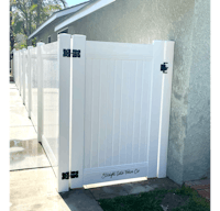 a white fence in front of a house