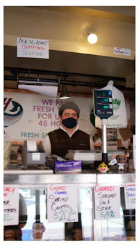 a man wearing a mask in front of a counter