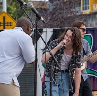 a group of people singing into a microphone