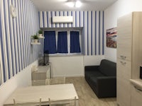 a small apartment with blue and white striped walls