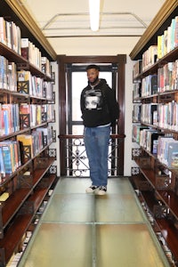 a person standing on a glass floor in a library