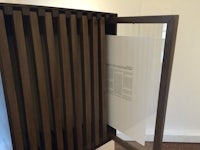 a wooden display case with a paper in it