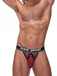 a man is posing in a thong underwear