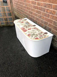 a white storage box with a floral pattern on it