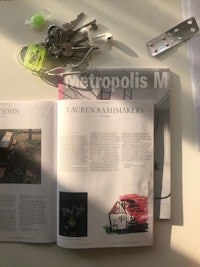 a magazine is open on a table with keys on it
