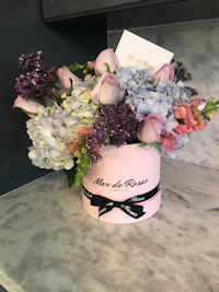 a pink and purple flower arrangement on a table