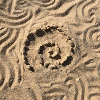 an image of a spiral in the sand
