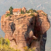 an elephant sits on top of a rock in greece