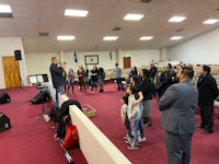 a group of people standing in a church