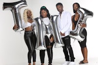 a group of people holding balloons with the word mt
