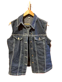 a women's denim vest hanging on a hanger