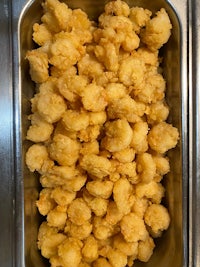 a tray full of fried calamari sitting on a table