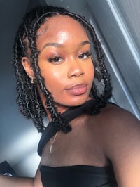 a woman wearing a black top and a pair of twists