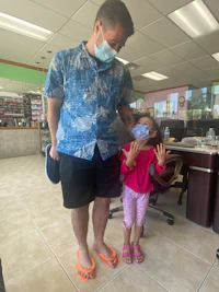 a man and a little girl in a dental office