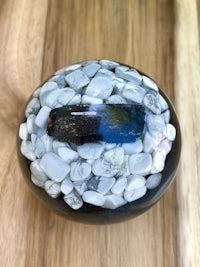 a black and white stone ball on top of a wooden table