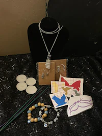a necklace, earrings, bracelet, and other items are on a table